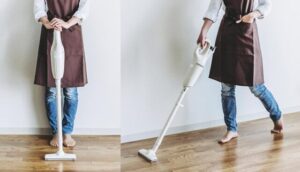 スティッククリーナーで掃除する女性